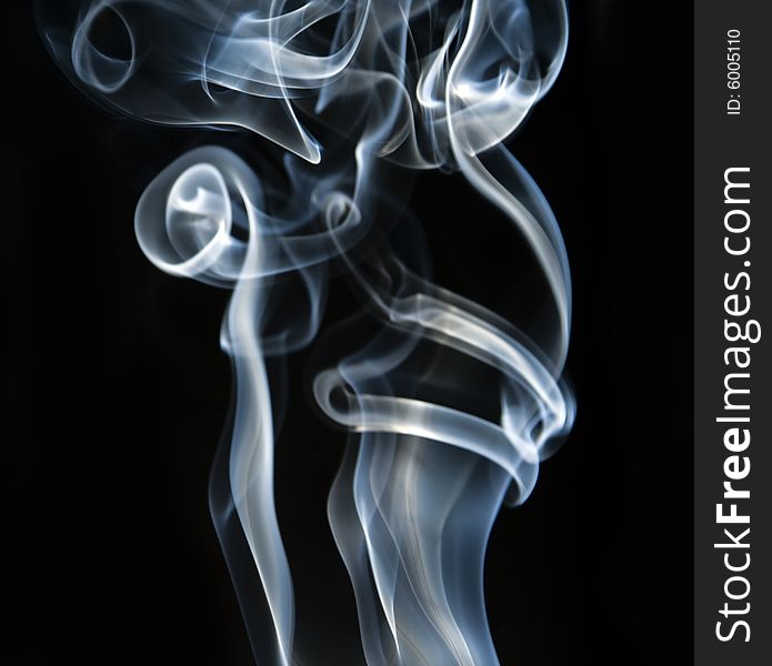 Colorful smoke curls isolated on black. Colorful smoke curls isolated on black