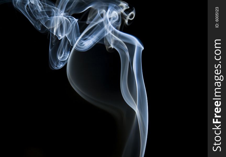 Colorful smoke curls isolated on black. Colorful smoke curls isolated on black
