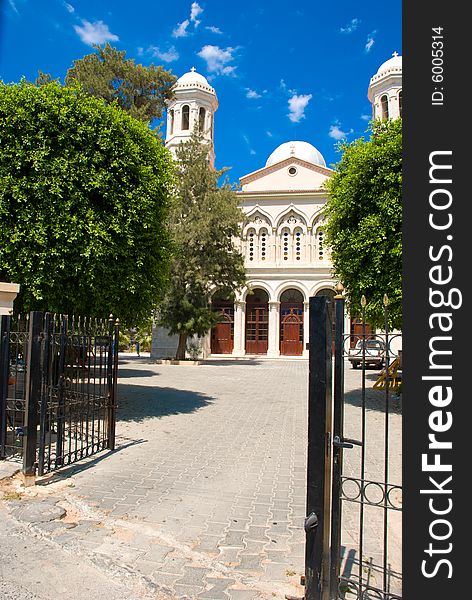 Path to church through steel gate with blue sky background. Path to church through steel gate with blue sky background