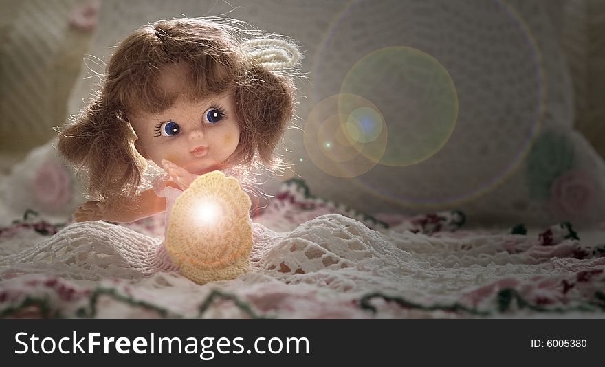 Toy doll reflecting light and looking at the light flares. Toy doll reflecting light and looking at the light flares.