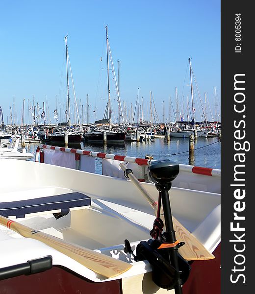 Small motor boat with wooden paddle in the harbour. Small motor boat with wooden paddle in the harbour.