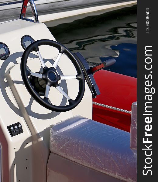 New motor boat wheel and control panel close up. New motor boat wheel and control panel close up.