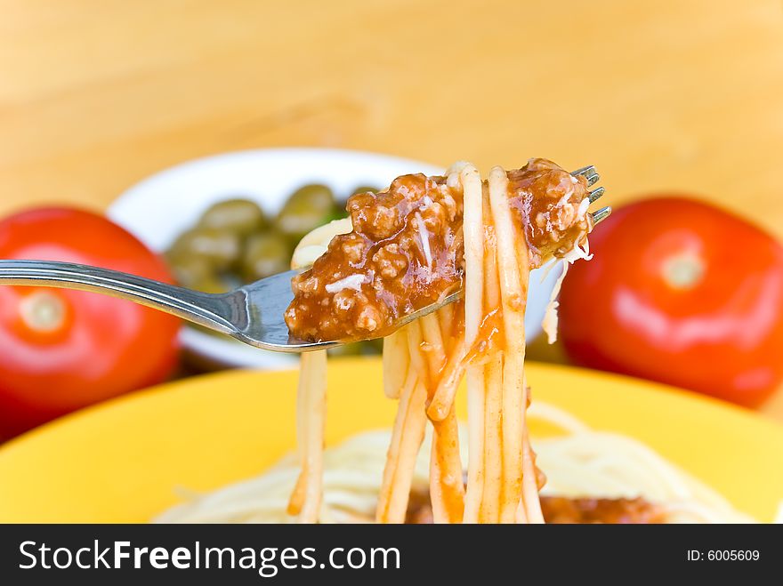 Spaghetti bolognese with parmesan cheese .