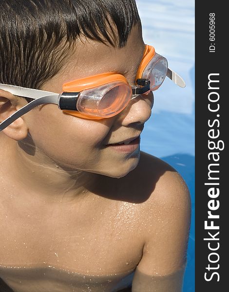 Young boy in pool with goggles on. Young boy in pool with goggles on