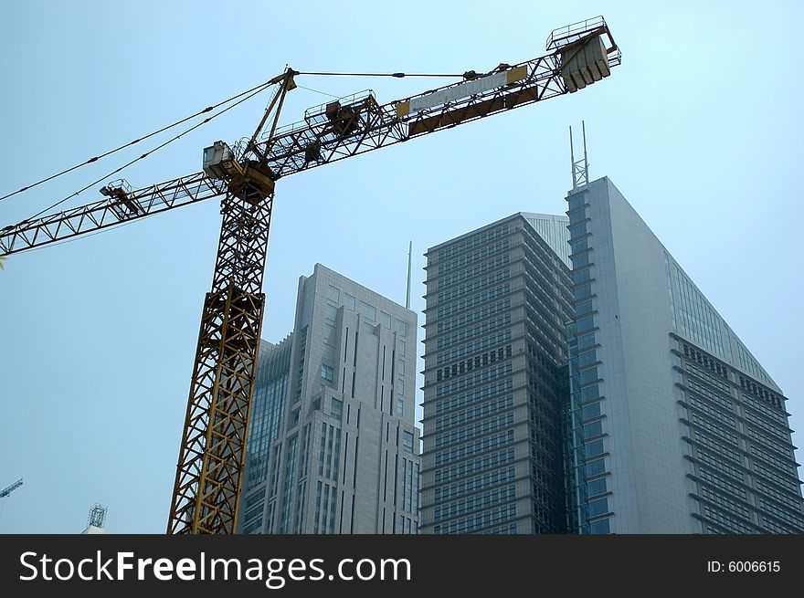 China, Shanghai. Finished modern office buildings together with crank. New skyscrapers still under construction. China, Shanghai. Finished modern office buildings together with crank. New skyscrapers still under construction.