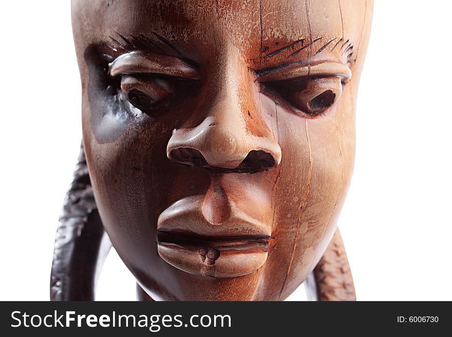 Ancient wooden sculpture from Africa on a white background.