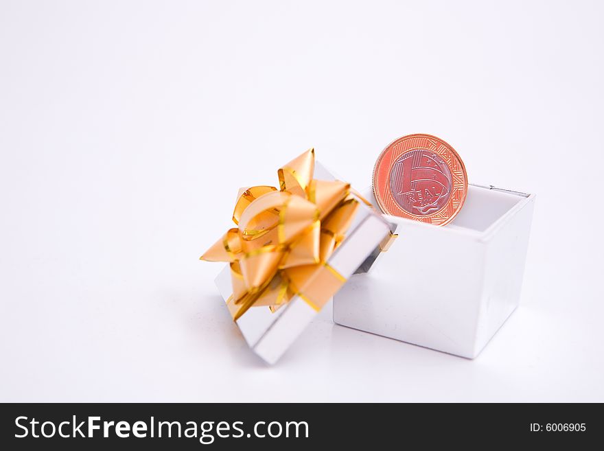 Box to gift and coin on the white background