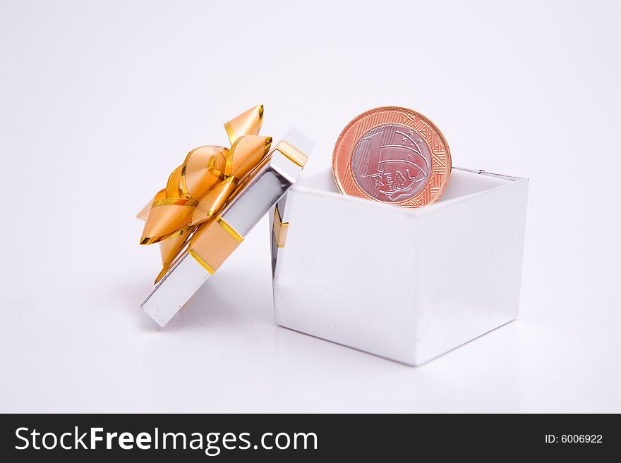 Box to gift and coin on the white background