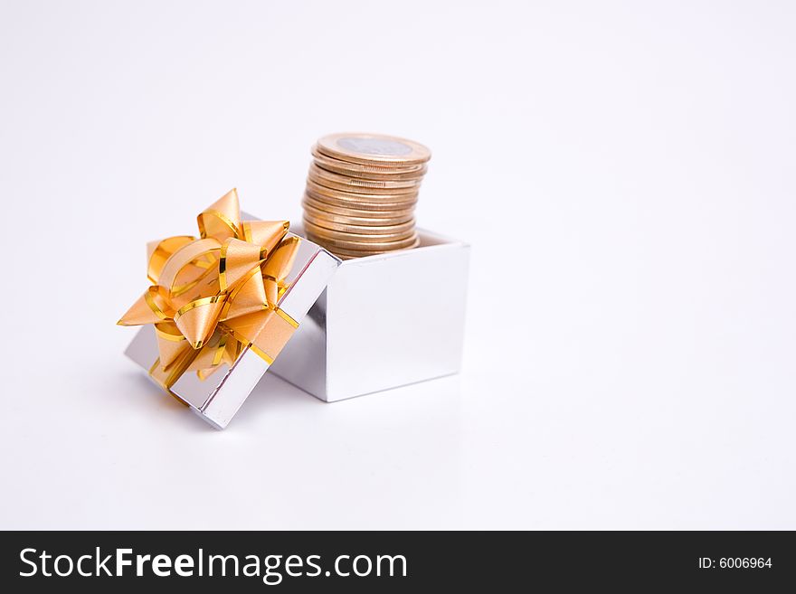 Box to gift and coin on the white background