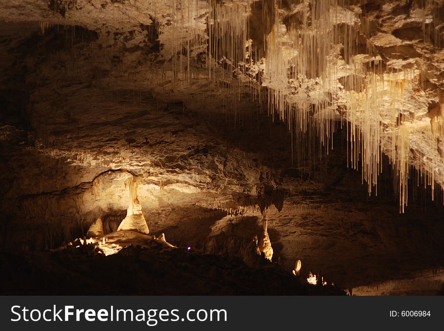 Tall unusual stalagmites and stalactites in the underground cavern in france, horizontal