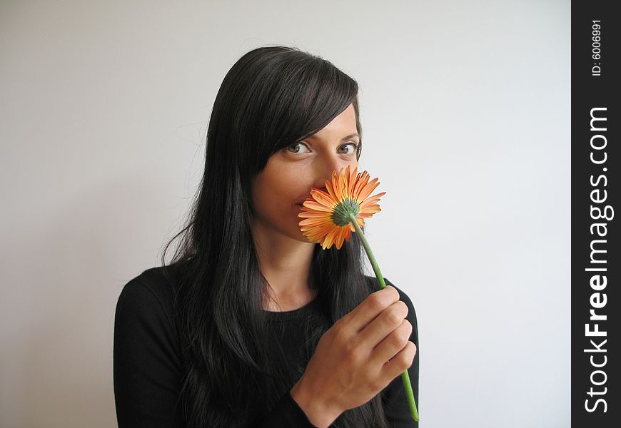 A pretty girl smelling a flower