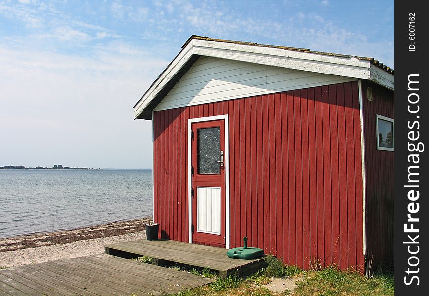 Small beautiful red summerhouse by the sea. Small beautiful red summerhouse by the sea