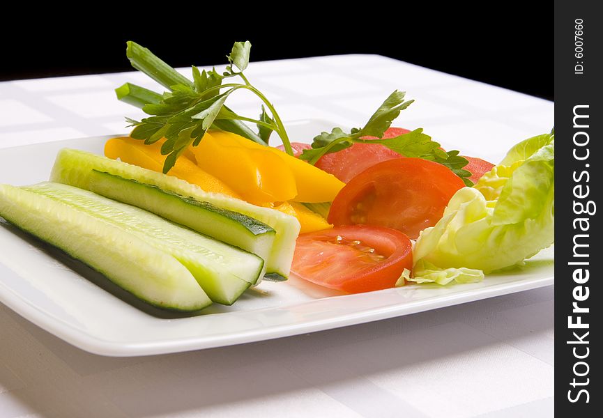 Vegetables with herbs on white plate