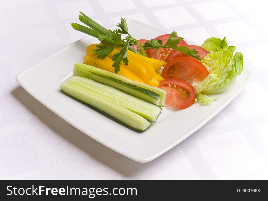 Vegetables with herbs on white plate