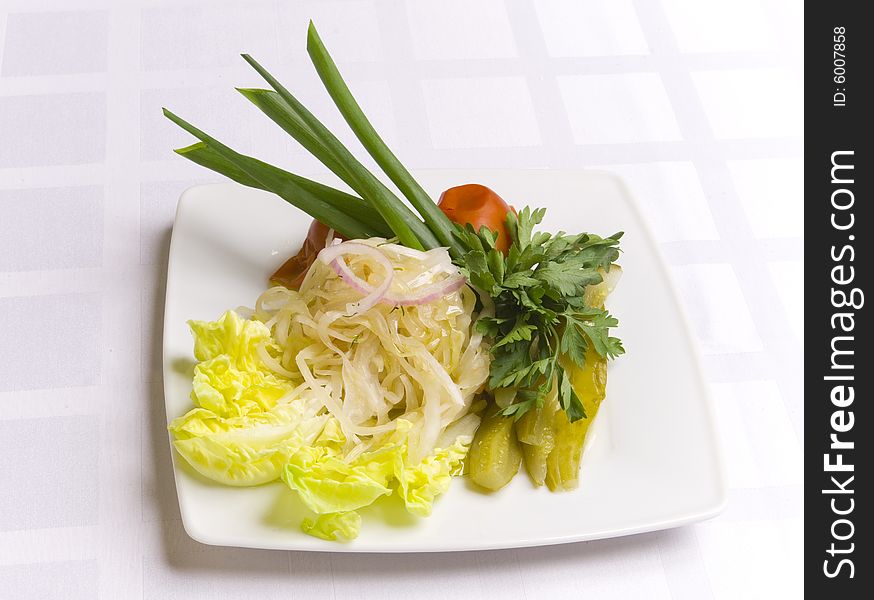Pickled vegetables decorated with salsad, onion and parsley. Pickled vegetables decorated with salsad, onion and parsley