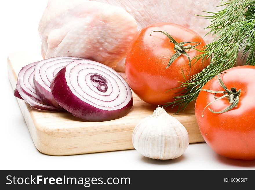 Fresh chicken with vegetables on a white background. Close up.