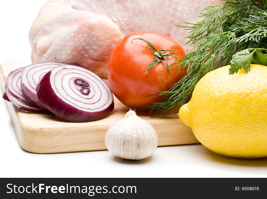 Fresh chicken with vegetables on a white background. Close up.