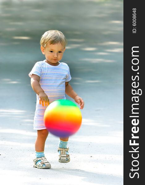 Boy with colorful ball on blurred background