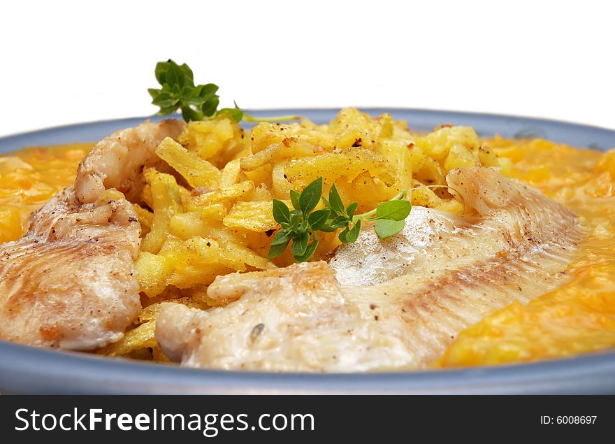 Alaska pollock on thin fries with delicious mango sauce arranged on a blue plate. Isolated on white background. Alaska pollock on thin fries with delicious mango sauce arranged on a blue plate. Isolated on white background.