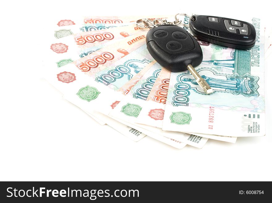 Car keys and money on a white background