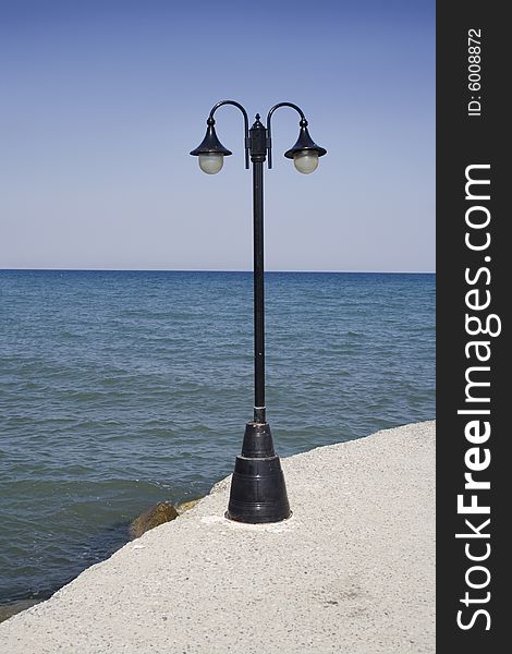 Lamp-post in front of sea horizon. Lamp-post in front of sea horizon