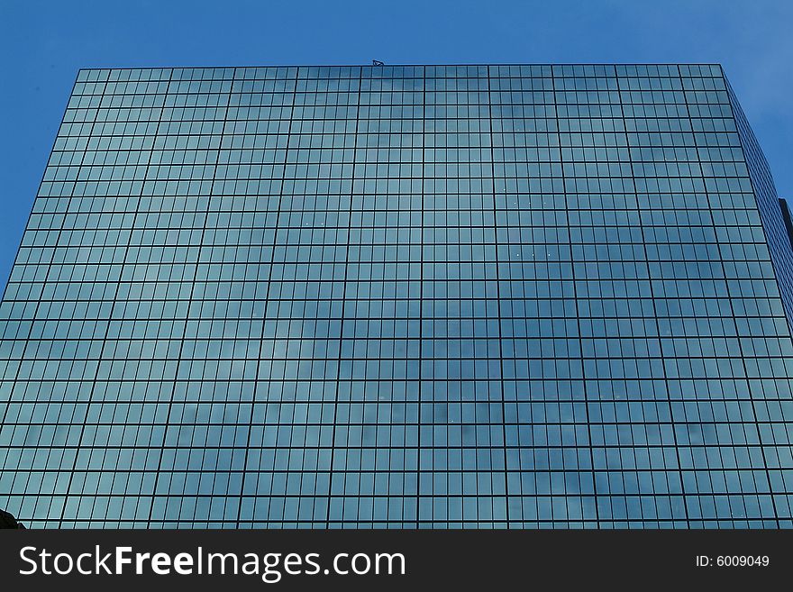 Skyscraper windows with reflection of older building