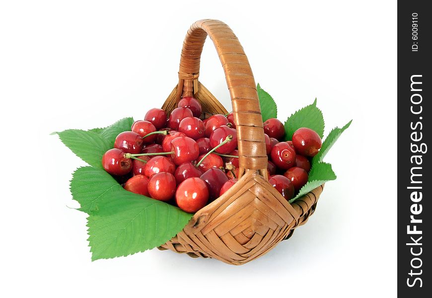 Cherries in a basket isolated on white background.