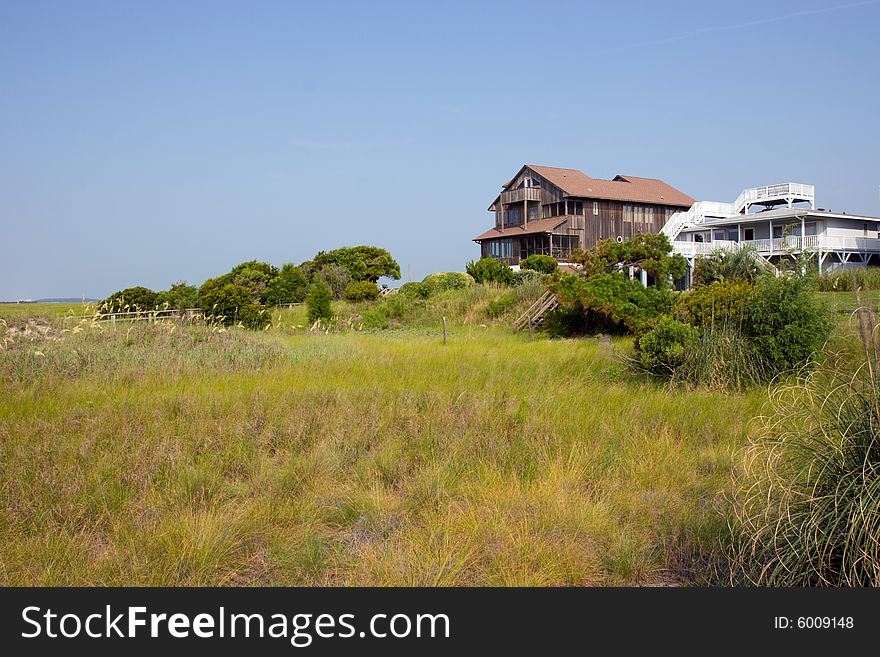 Vacation homes seen across the grassy sand dunes. Vacation homes seen across the grassy sand dunes