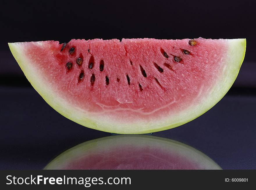 Piece of watermelon against the black background. Piece of watermelon against the black background