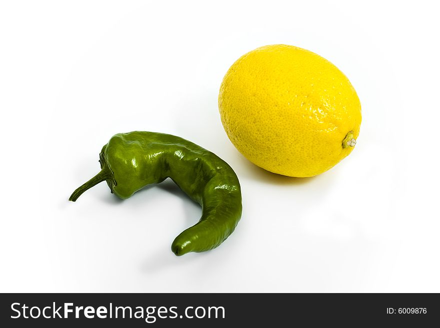 Green pepper and yellow lemon on white background. Green pepper and yellow lemon on white background