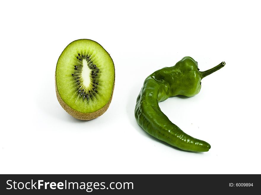 Green pepper and cut kiwi on white background. Green pepper and cut kiwi on white background