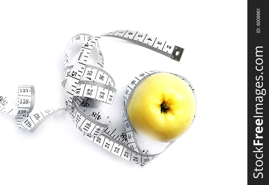 Tape measures and yellow apple isolated on white. Tape measures and yellow apple isolated on white