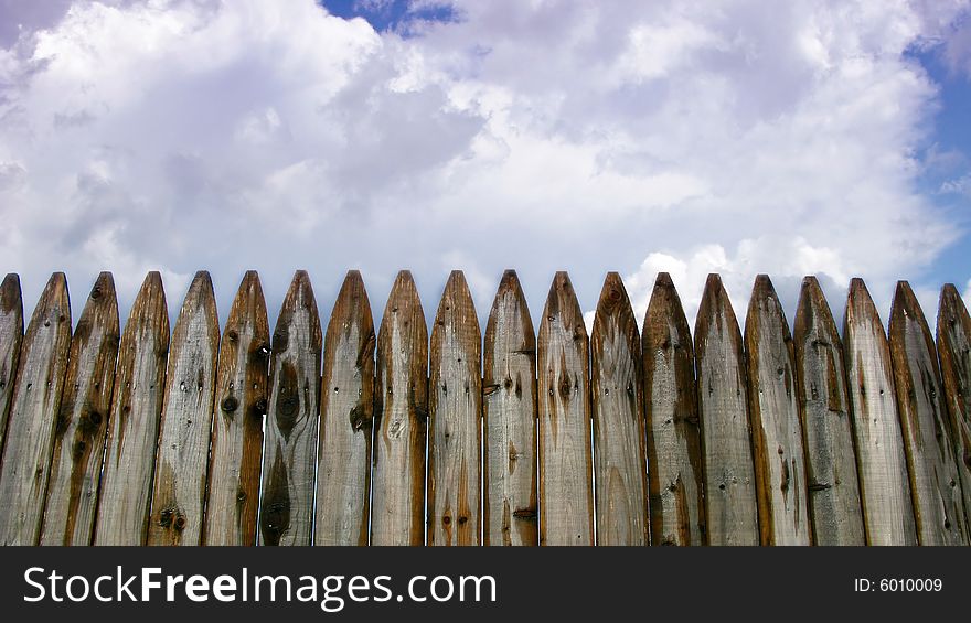 Wooden Fence And Clouds