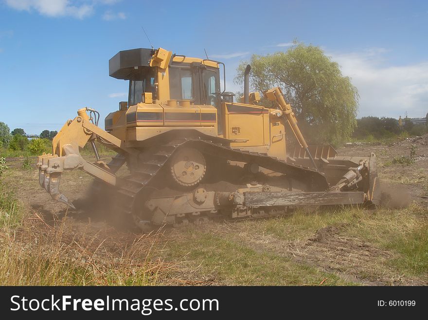 Yellow big bulldozer working in construction site