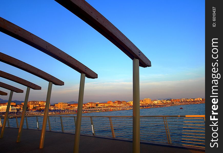 The view of a glimpse of Versilia coast by the dock of Lido di Camaiore. The view of a glimpse of Versilia coast by the dock of Lido di Camaiore