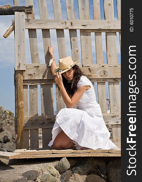 Young attractive woman posing on old wood fence. Young attractive woman posing on old wood fence