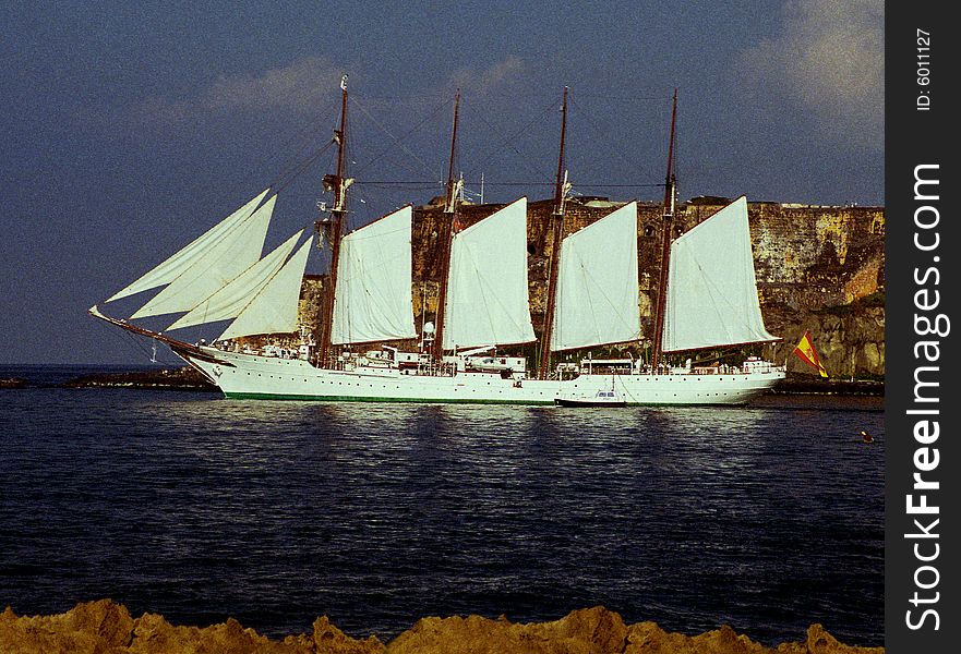 Sailbot going through the harbor at dawn. Sailbot going through the harbor at dawn