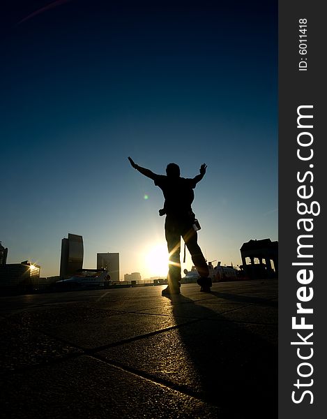 A man rising his hand with a silhouette effects in one fine morning. A man rising his hand with a silhouette effects in one fine morning