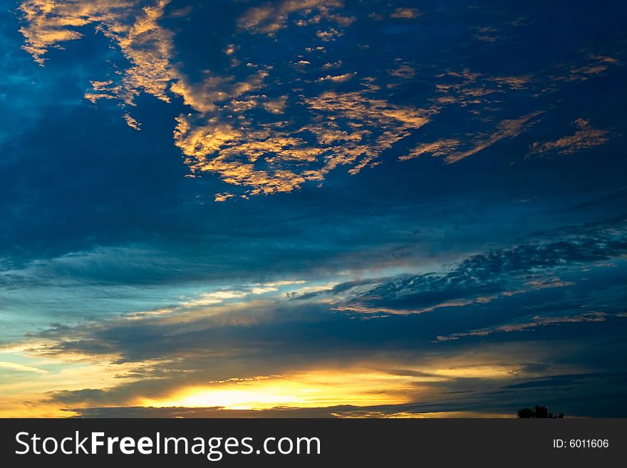 An image of dramatic sunset wit blue and orange clouds