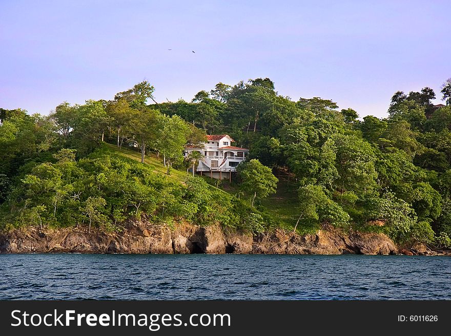 A large white villa on a hillside on a tropical island. A large white villa on a hillside on a tropical island