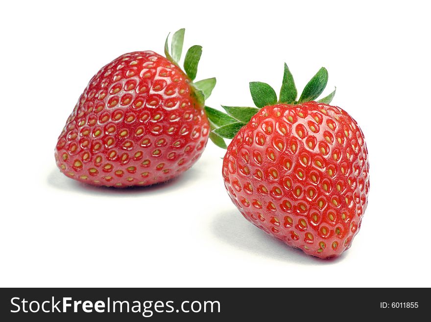 Two ripe strawberries on white background