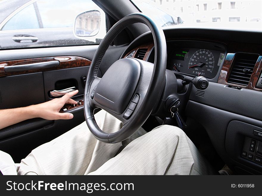 Driver siting in a car and steering wheel. Driver siting in a car and steering wheel