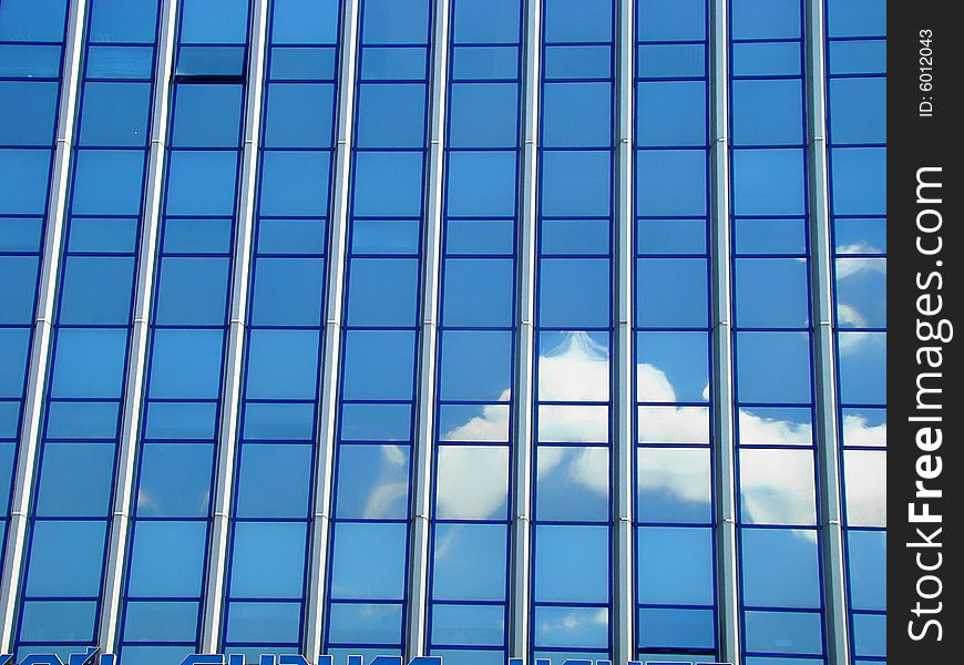 Modern city building. Construction from glass and metal. Dark blue sky is reflected in glass. Modern city building. Construction from glass and metal. Dark blue sky is reflected in glass.