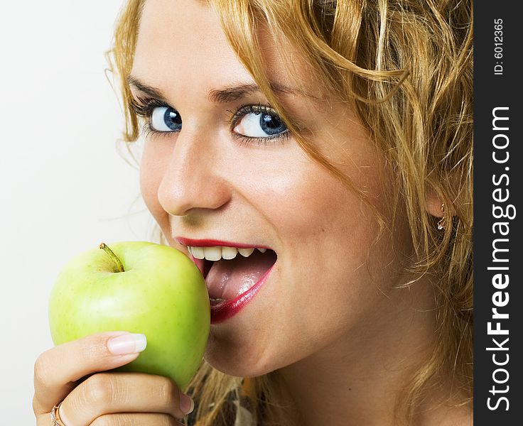 Young beautiful girl eating apple.