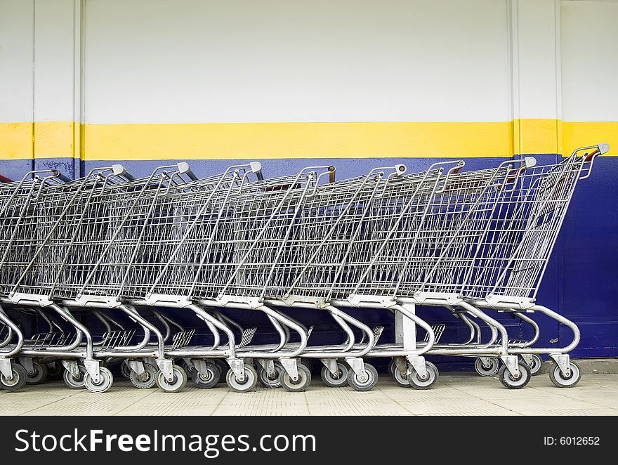 Line of old style shopping carts outside a supermarket. Line of old style shopping carts outside a supermarket