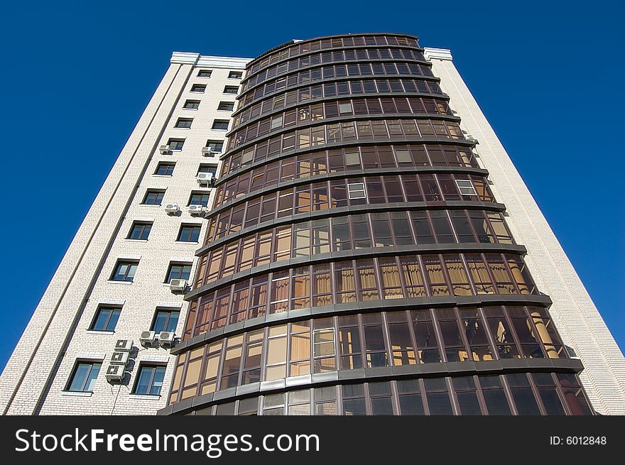 High modern office building with blue sky background