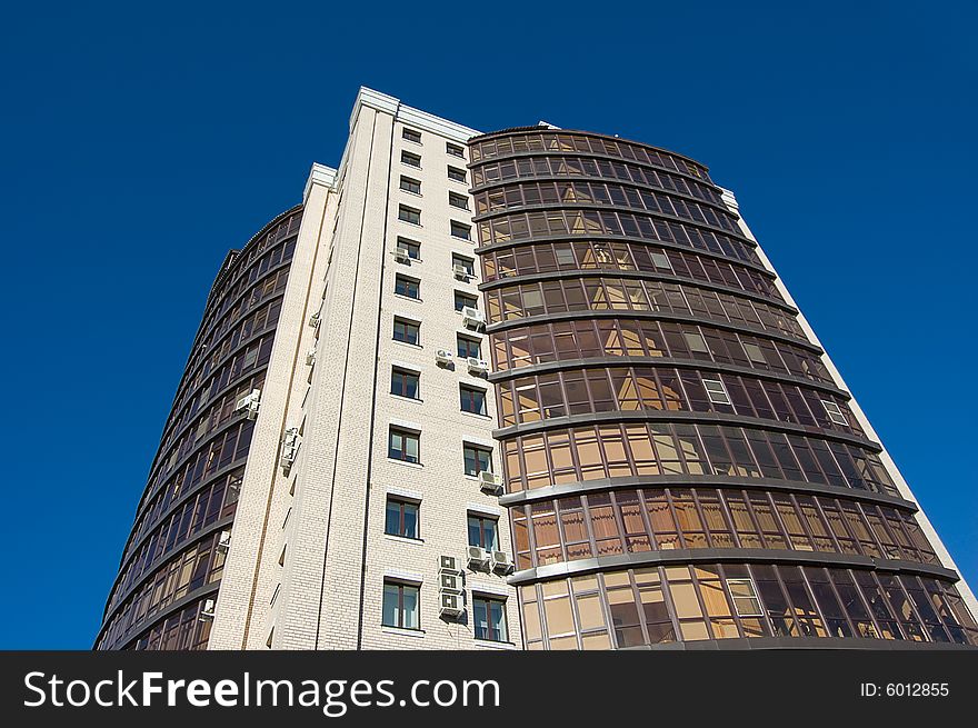 High modern office building with blue sky background