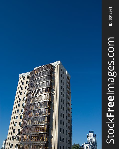 High modern buildings on blue sky - close and far away. High modern buildings on blue sky - close and far away