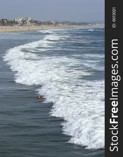 Waves coming ashore on sunny afternoon at Santa Monica Beach in California. Waves coming ashore on sunny afternoon at Santa Monica Beach in California.