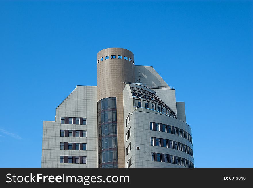 High modern office building with blue sky background